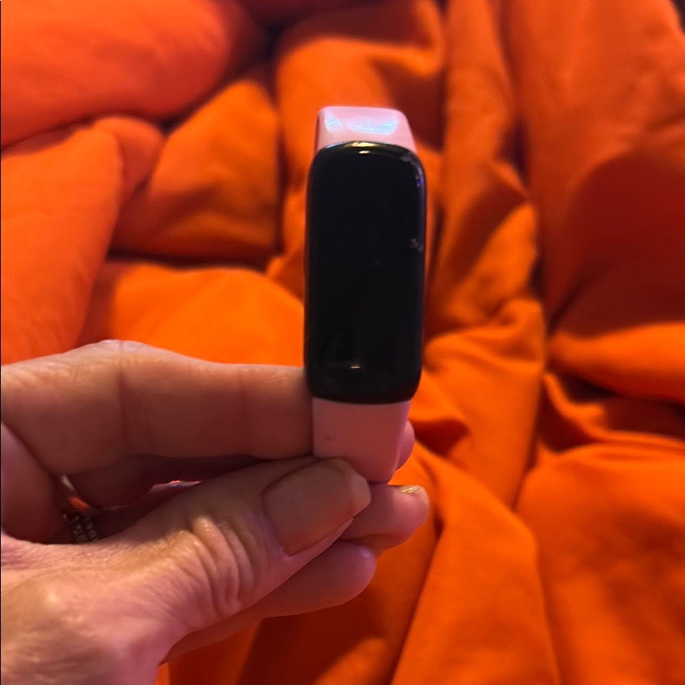 Pink and black Fitbit